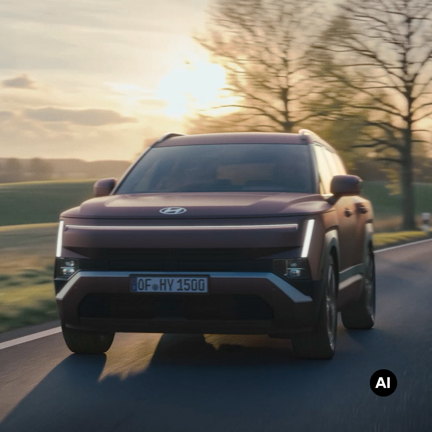 Hyundai TUCSON driving along a road with the sun setting in the background.
