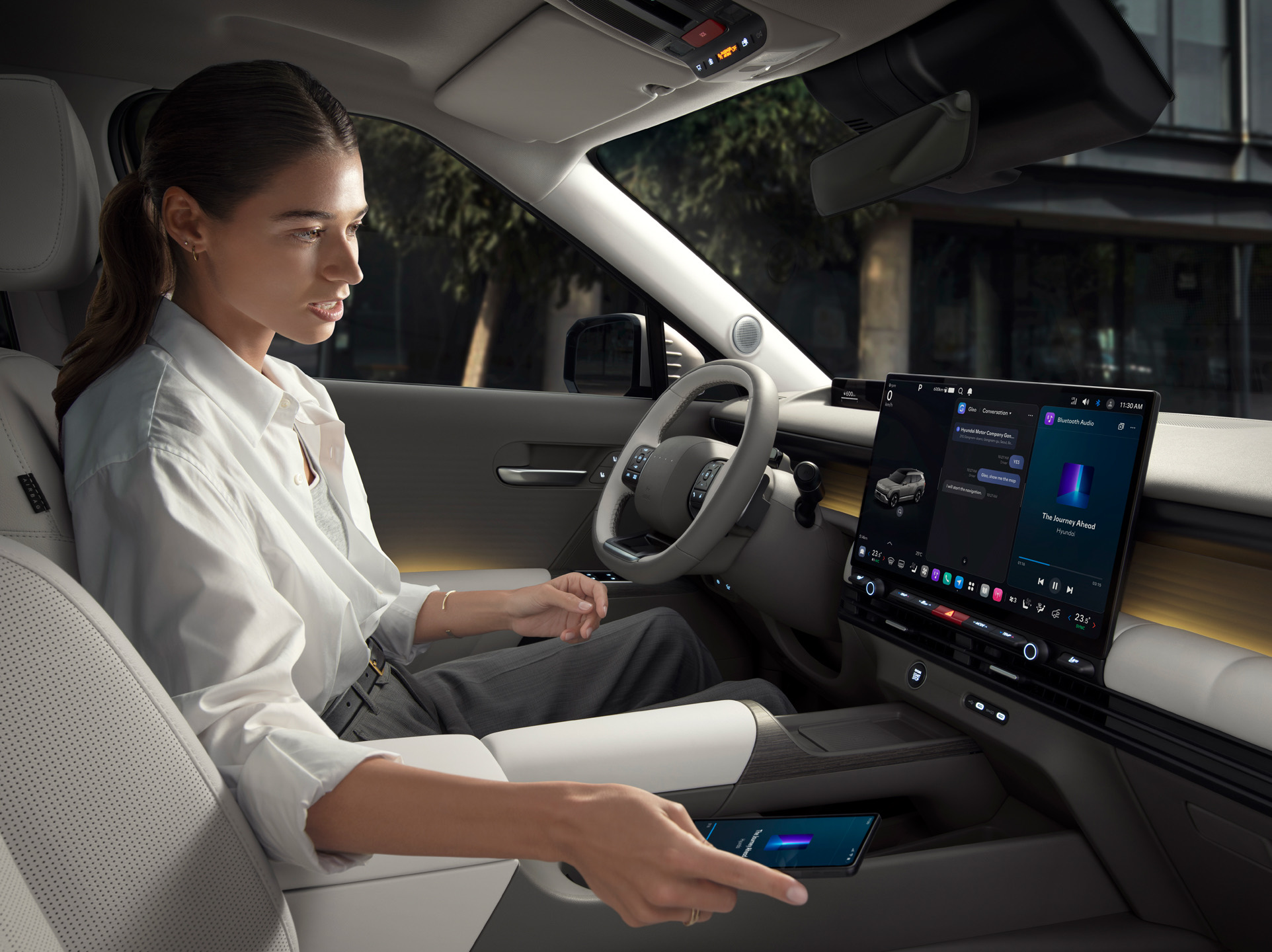 A woman sitting in the driving seat of Hyundai TUCSON using GLEO AI.